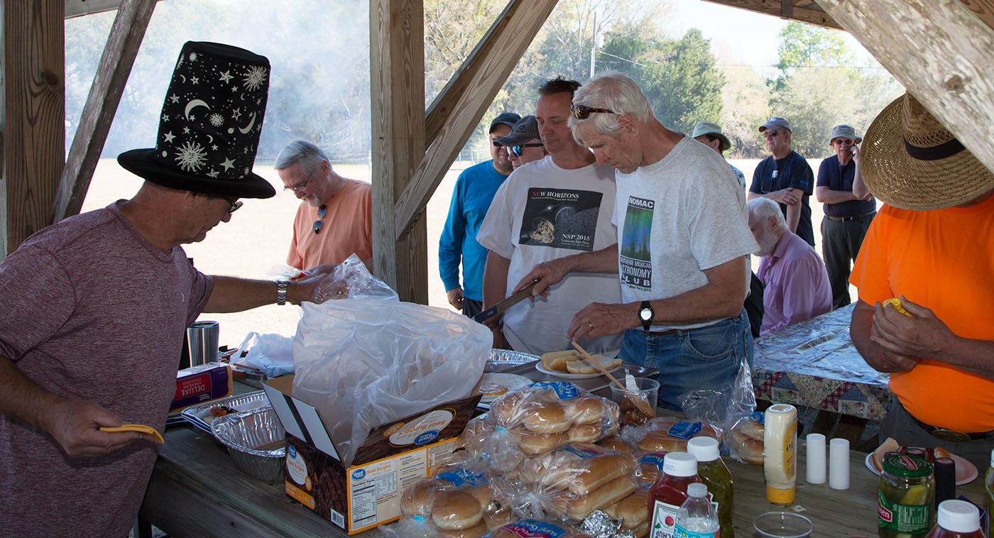 Marty Moyer and John Hilliard (left) prepare materials for the grill and serving line on the right.