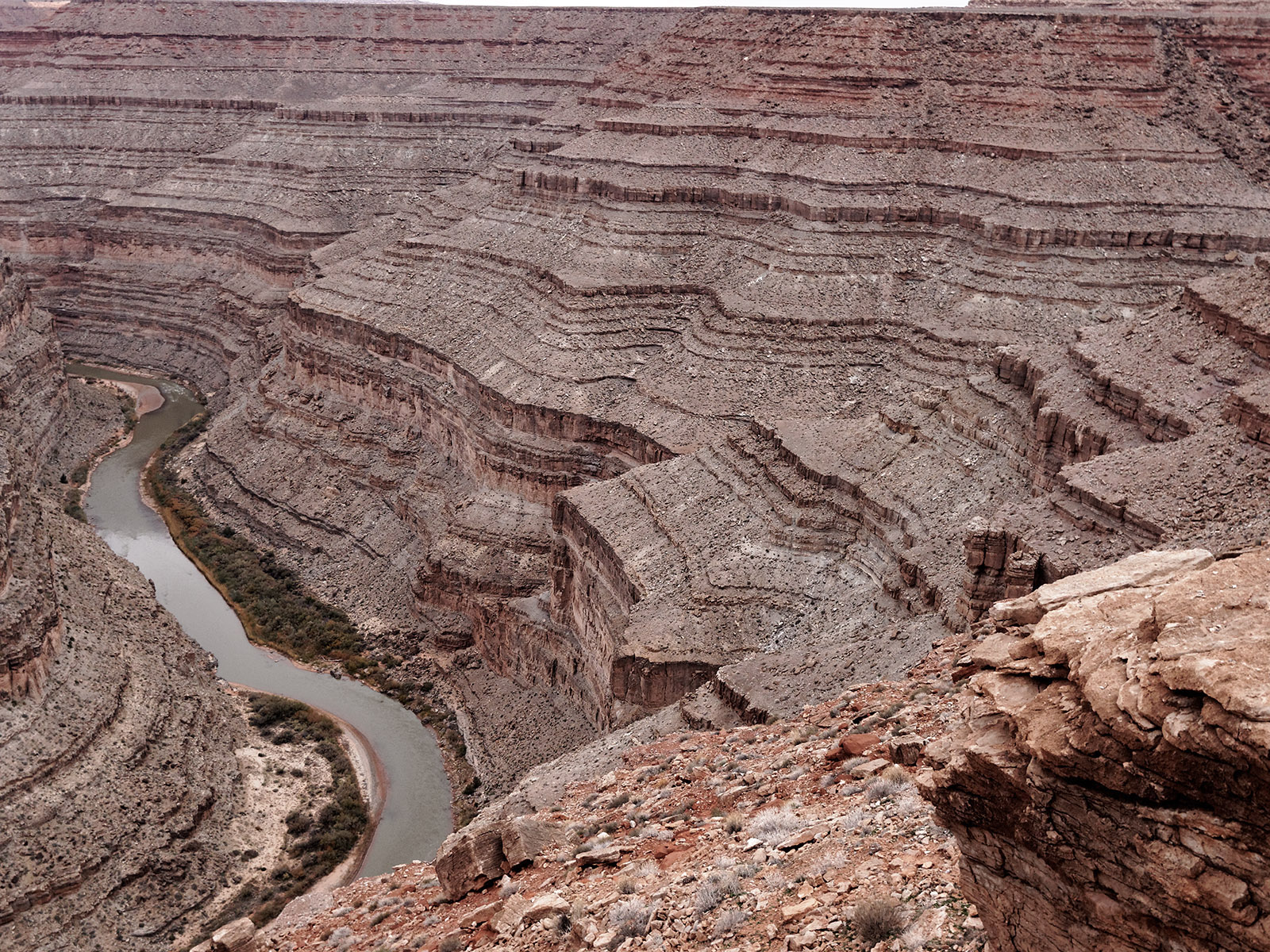 Detail of Goosenecks limestone and shale above San Juan River.   The bottom steep layers are from Paradox Formation – 300-310 million years ago.  The upper sloped layers are from Honaker Trail Formation - 270-300 million years ago.