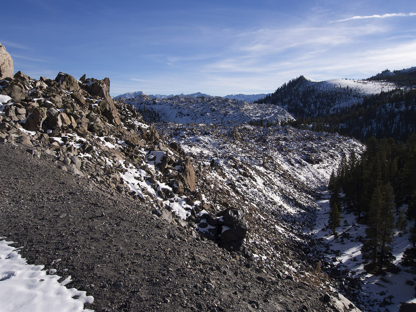 Obsidian Dome:  Massive mound of obsidian and pumice partially covered by snow.  This is a young volcanic dome in the Inyo Domes group.  This was produced by a slow, oozing magma flow about 600 years ago.