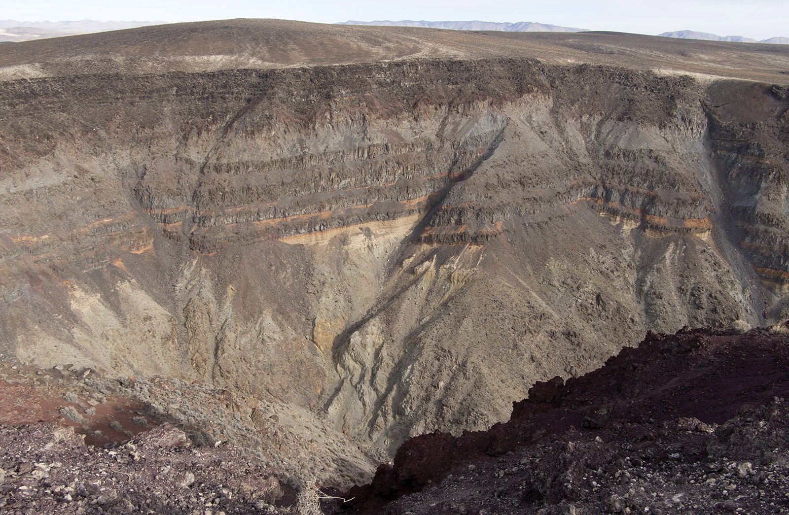 Upper wall of Rainbow Canyon with top layer of basalt from the Pliocene Epoch (2-4 million years ago) over Paleozoic Era strata originally deposited under shallow seas more than 250 million years ago.