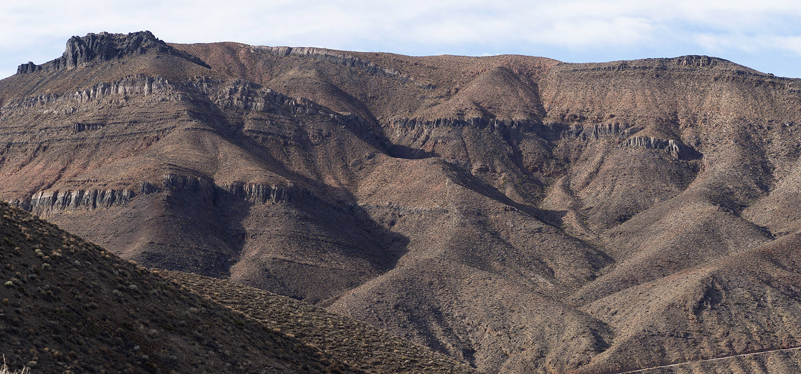 Mountain composed predominantly of Cambrian Period strata from Carrera Formation shale and limestone.
