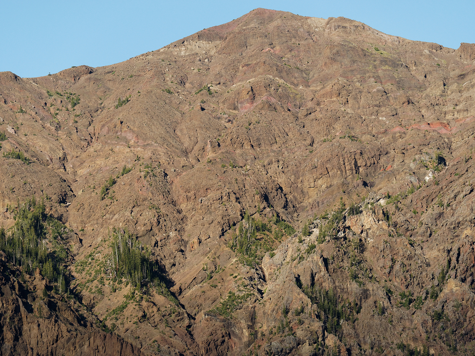 Layers of eroded andesitic deposits and brecca from the Absaroka Volcanic Supergroup are at the base of Pilot Peak.