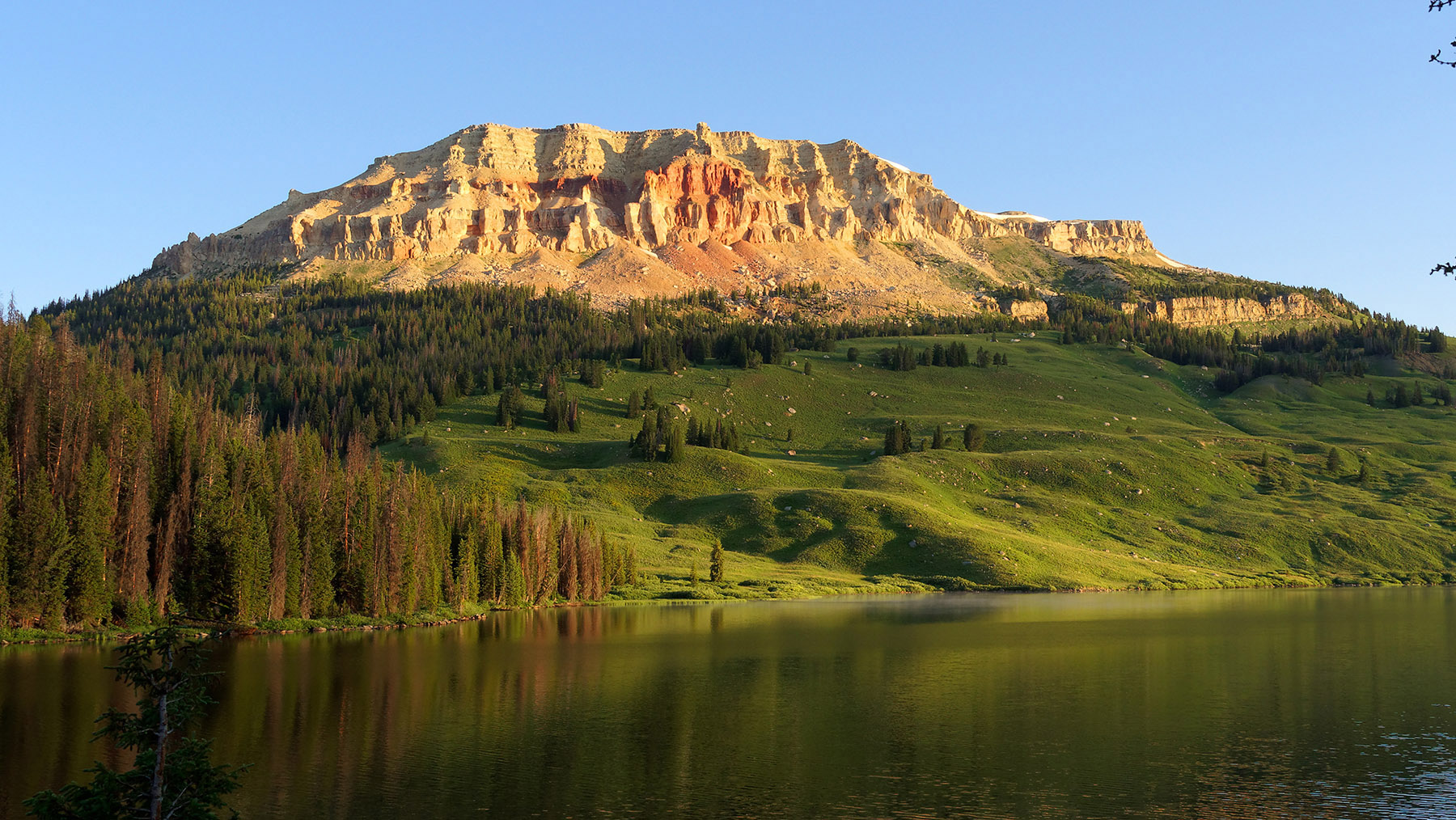 Beartooth Lake and Beartooth Butte.  Residual sedimentary layers from the Paleozoic Era (Cambrian through Devonian, 550-350 MA) escaped glacier erosion and represent deposits laid down during periods of rising and fall seas in the Western Interior Seaway.  There is a mixture of limestone, shale, sandstone and dolomite.