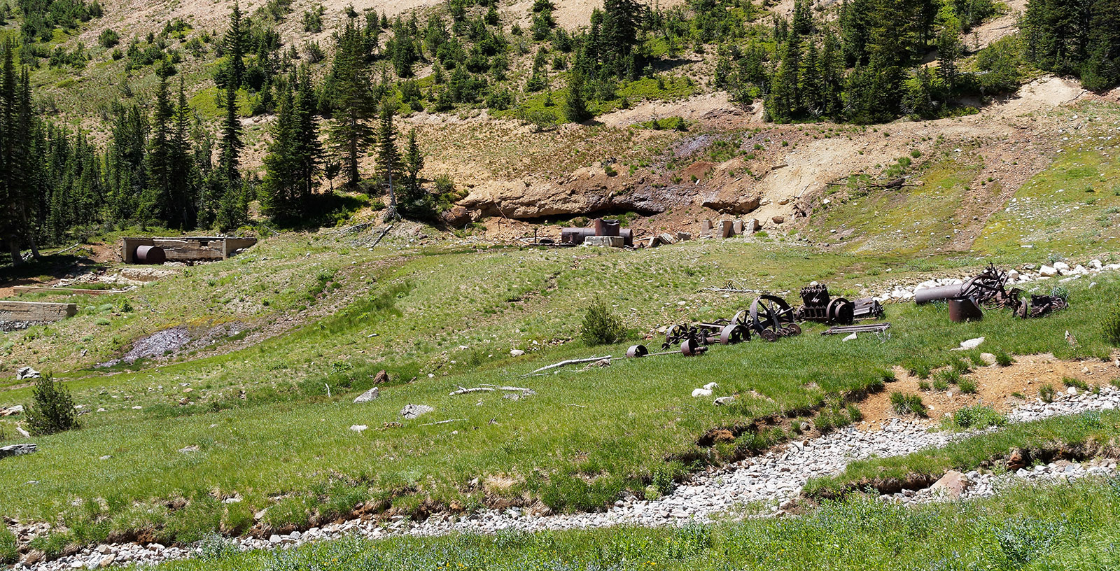 Lulu Pass Contact Mine Ruins and machinery.  The mine was active from 1910's through 1925.  Pyritic gold ore removed from the volcanic mountain above was processed and shipped to Cooke City.  Limestone and dolomite rocks are in the stream beds.