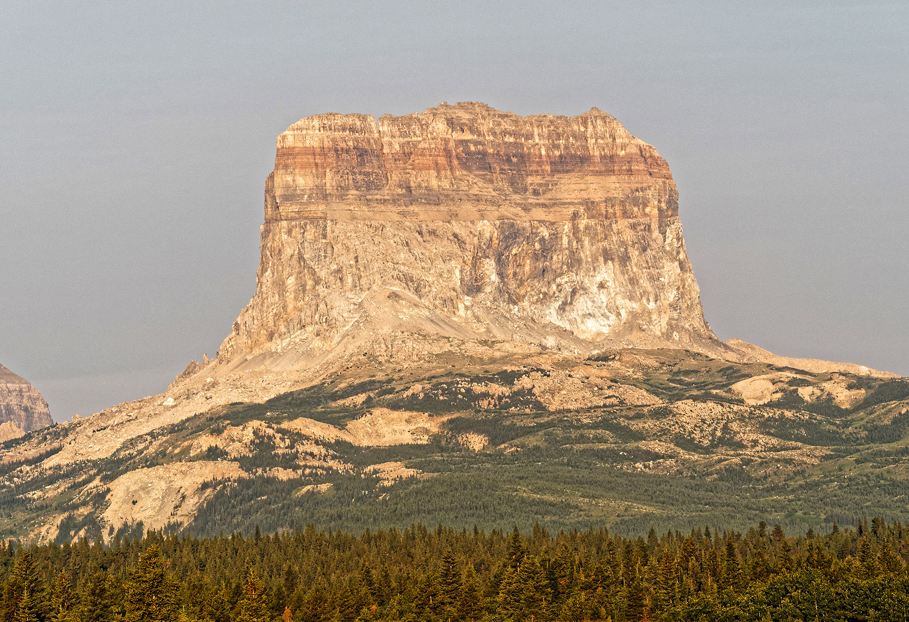 Chief Mountain with Appekunny Formation and Altyn Formation deposits from the Protozeric Eon (1,600-800 MA) above a base of Cretaceous sediment (63 MA).