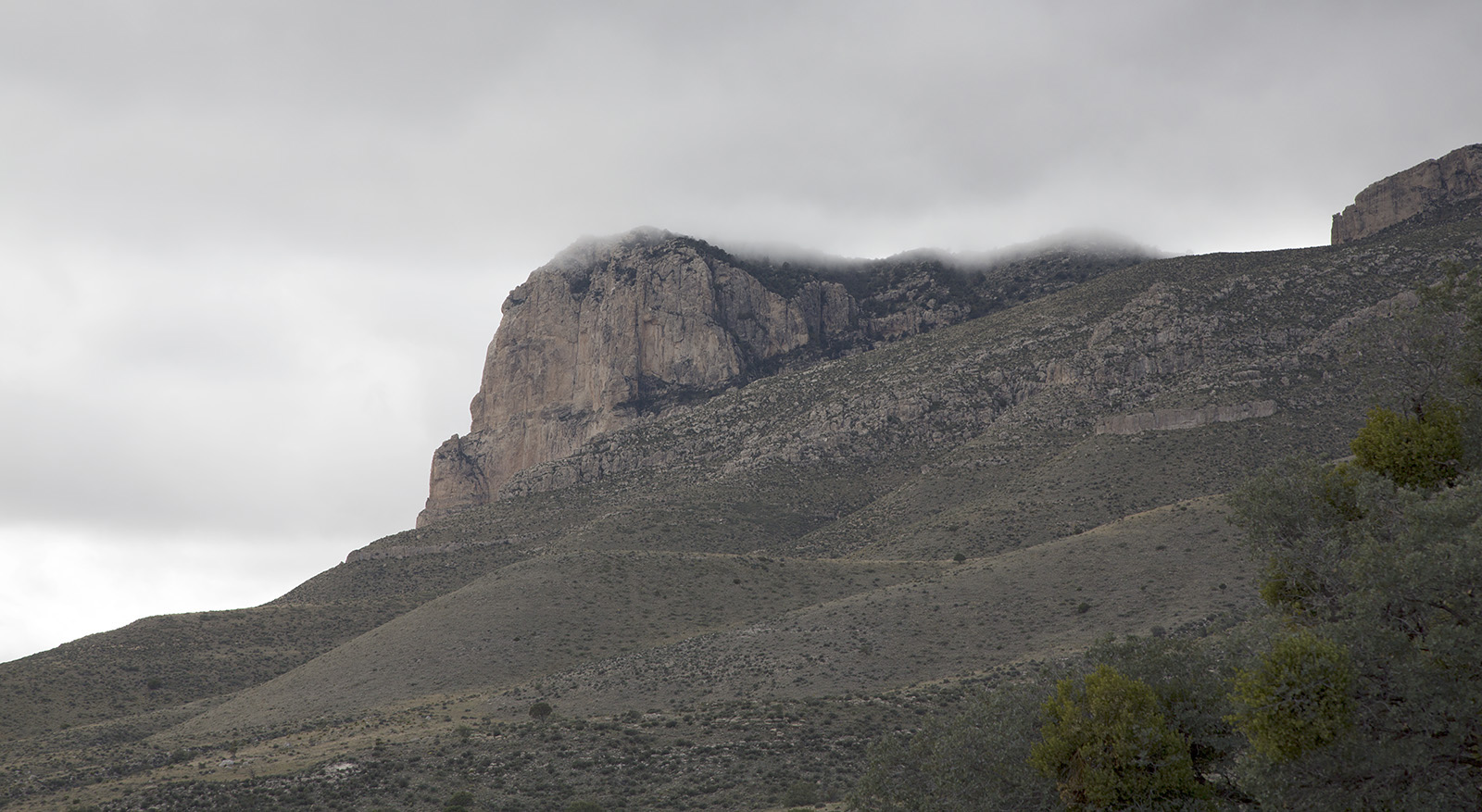 Capitan peak becomes visible as clouds lift in the afternoon.  The is the most prominent part of the Guadelupe mountains that formed from Capitan reef, a large tropical reef surrounding a Permian Period sea whose floor now is the Delaware Basin.